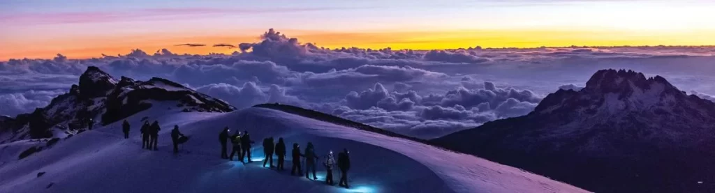 A breathtaking view of Mount Kilimanjaro, the highest peak in Africa, surrounded by clouds.
